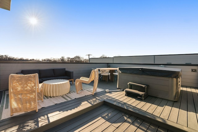 wooden terrace featuring an outdoor living space and a hot tub