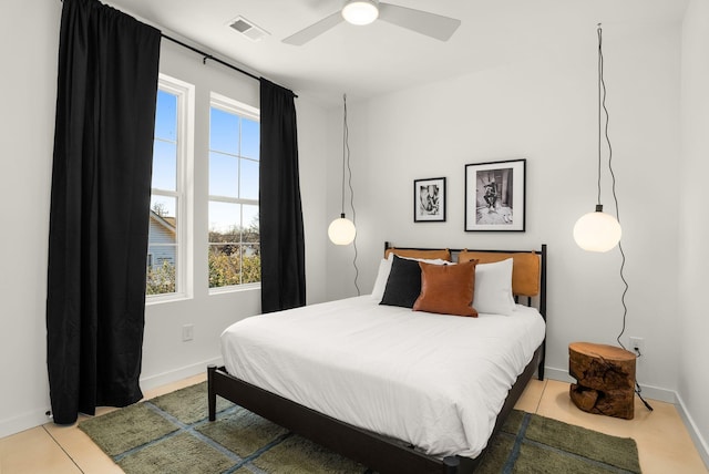 bedroom featuring baseboards, visible vents, and a ceiling fan