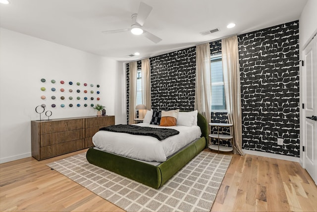 bedroom featuring recessed lighting, visible vents, baseboards, and wood finished floors