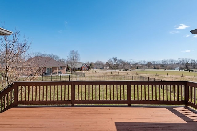 wooden terrace with a yard and fence