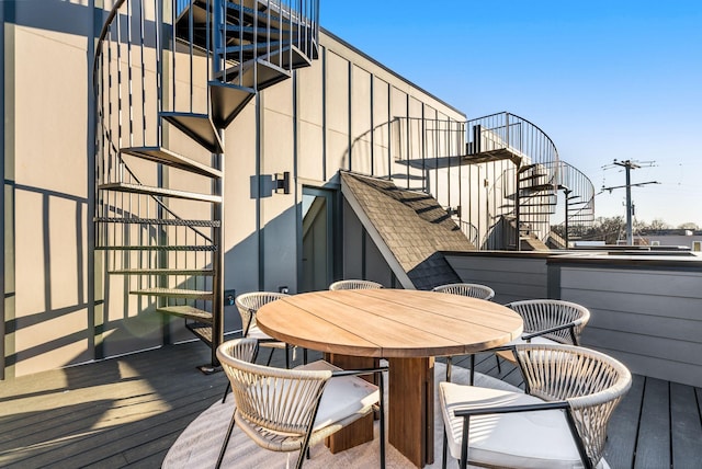 deck with outdoor dining area and stairway