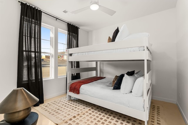 bedroom featuring baseboards, visible vents, and ceiling fan