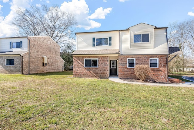 traditional home with brick siding and a front yard