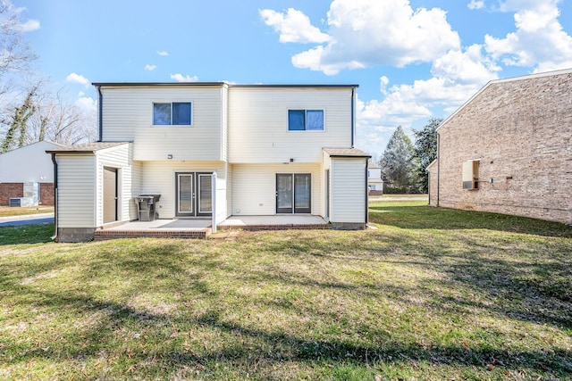 back of property featuring a yard and a patio area