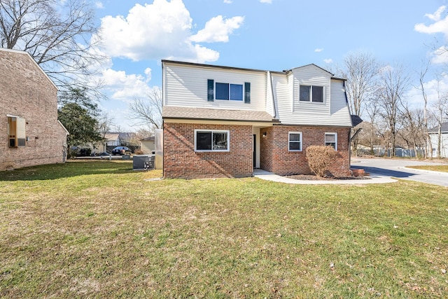 view of front of house with a front yard and brick siding