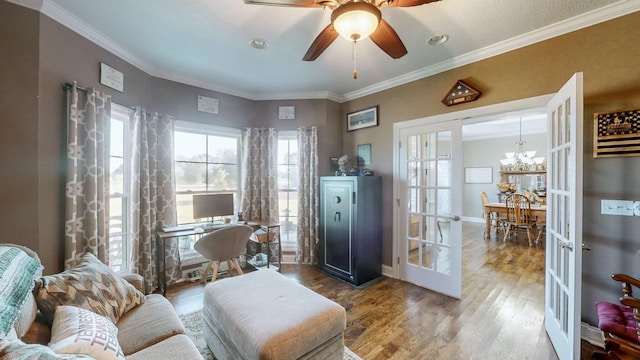 interior space featuring crown molding, baseboards, wood finished floors, and french doors