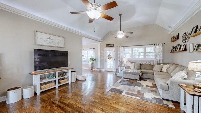 living area with ornamental molding, vaulted ceiling, baseboards, and wood finished floors