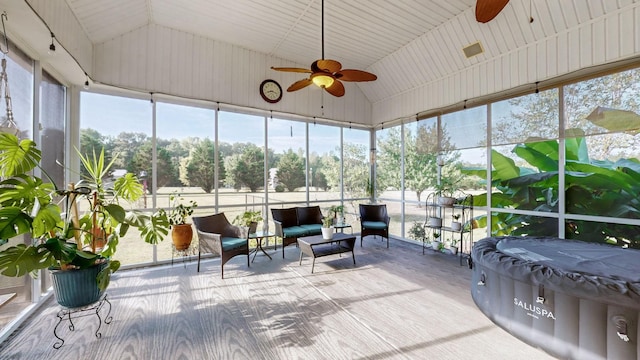 sunroom featuring lofted ceiling and ceiling fan