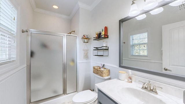 bathroom with wainscoting, crown molding, a shower stall, and vanity