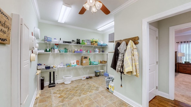 clothes washing area featuring a ceiling fan, crown molding, and baseboards