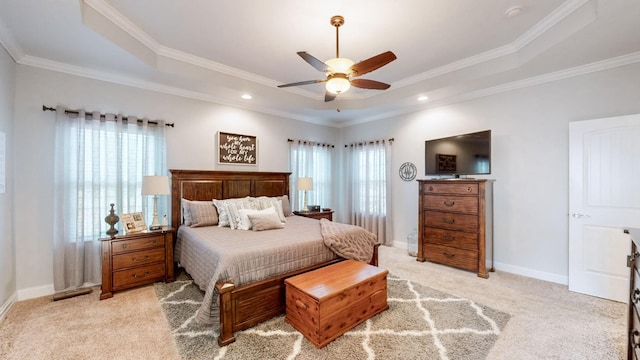 bedroom featuring multiple windows, baseboards, a raised ceiling, and light colored carpet