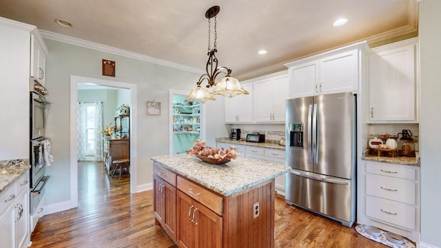 kitchen with stainless steel appliances, wood finished floors, white cabinetry, and a center island