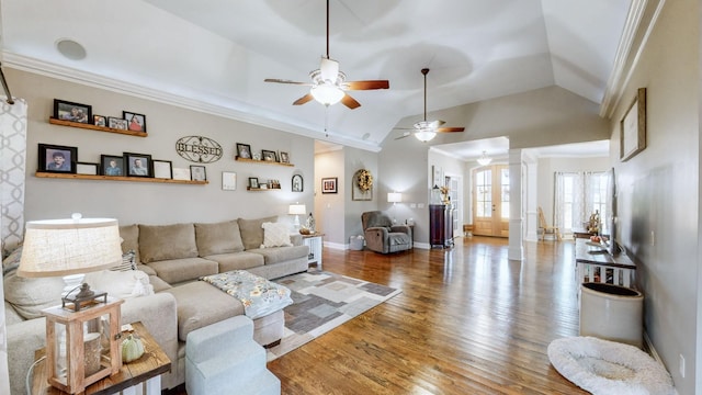 living room with crown molding, decorative columns, ceiling fan, wood finished floors, and baseboards