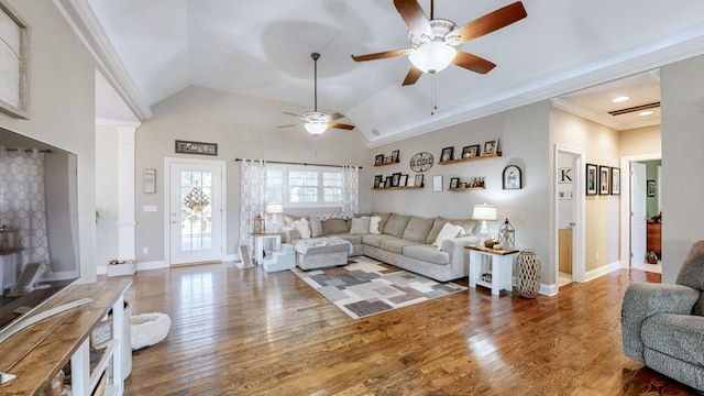 living room featuring lofted ceiling, ceiling fan, baseboards, and wood finished floors