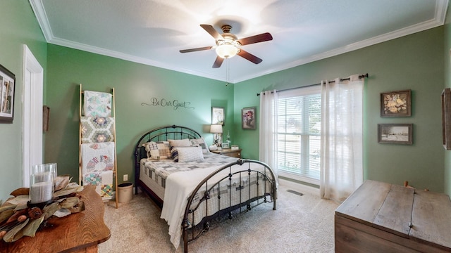 bedroom featuring ornamental molding, light colored carpet, ceiling fan, and visible vents