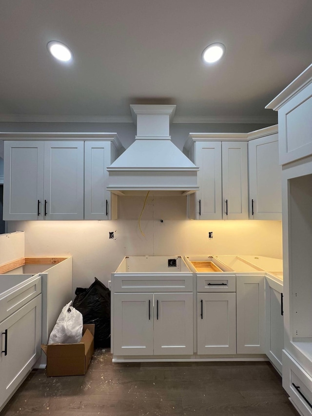 kitchen featuring ornamental molding, recessed lighting, white cabinetry, and custom range hood