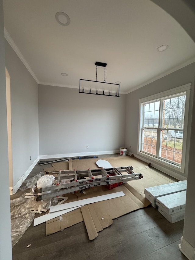 spare room with baseboards and crown molding