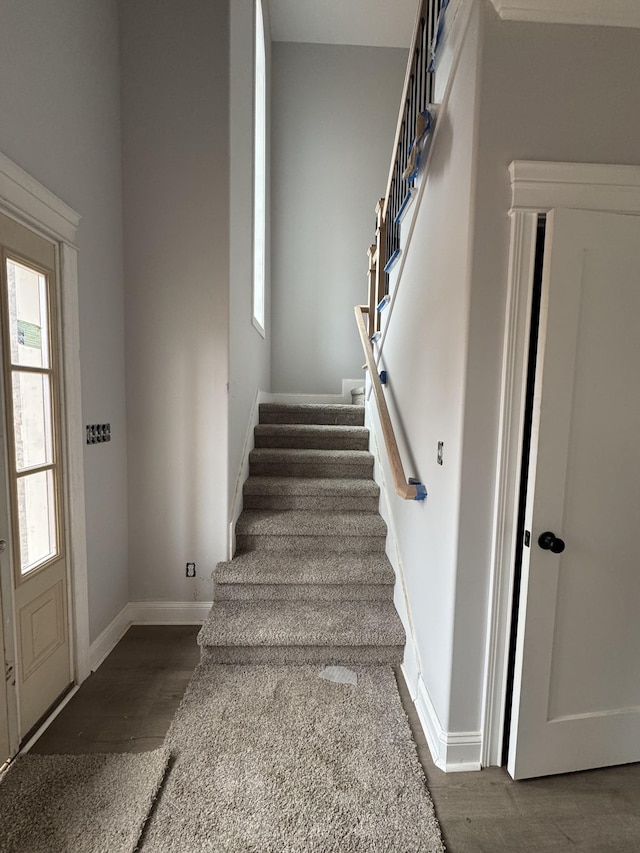 stairs with baseboards and wood finished floors