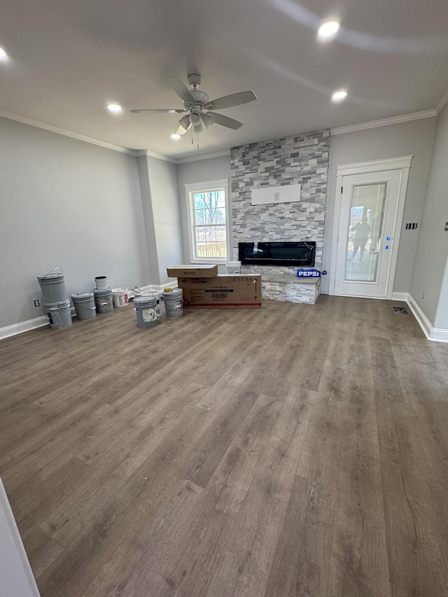 unfurnished living room with baseboards, a ceiling fan, dark wood-type flooring, crown molding, and recessed lighting