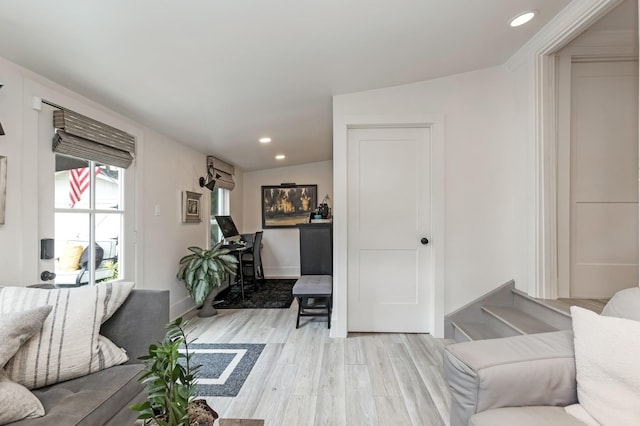 living room with baseboards, light wood finished floors, and recessed lighting