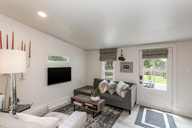 living room with light wood finished floors, baseboards, vaulted ceiling, and recessed lighting