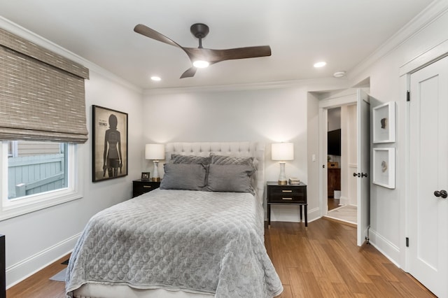 bedroom with ornamental molding, recessed lighting, baseboards, and wood finished floors