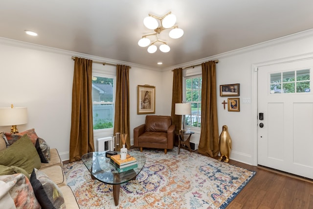 living room featuring baseboards, ornamental molding, wood finished floors, and recessed lighting