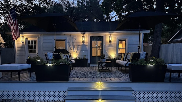 back of house featuring fence and an outdoor living space