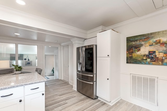 kitchen with crown molding, light wood-style flooring, visible vents, and stainless steel fridge with ice dispenser