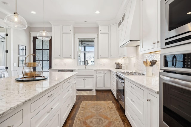 kitchen featuring light stone counters, dark wood-style floors, tasteful backsplash, appliances with stainless steel finishes, and white cabinets