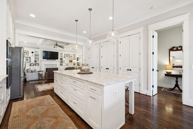 kitchen featuring white cabinetry, open floor plan, dark wood-type flooring, and a kitchen breakfast bar