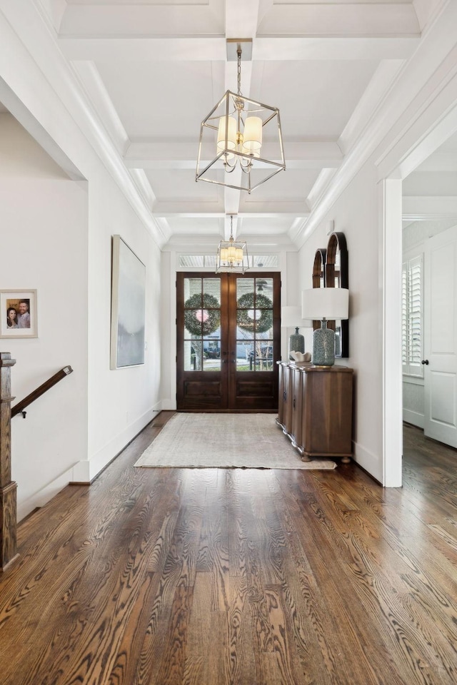 foyer with coffered ceiling, wood finished floors, beam ceiling, french doors, and a notable chandelier