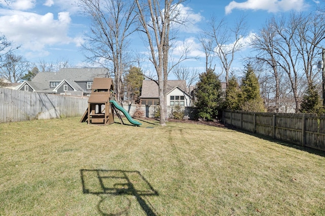 view of yard featuring a fenced backyard and a playground