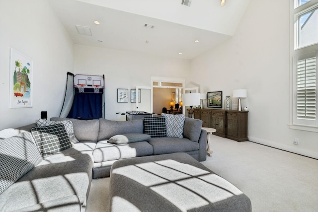 carpeted living area featuring visible vents, high vaulted ceiling, baseboards, and recessed lighting