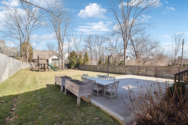 view of yard featuring a fenced backyard, a playground, and a patio