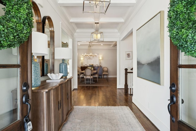 entryway featuring a chandelier, coffered ceiling, beamed ceiling, and wood finished floors