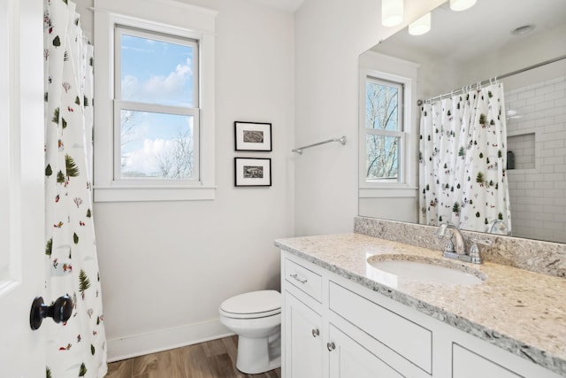 bathroom with toilet, wood finished floors, vanity, baseboards, and a shower with curtain