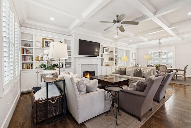 living room featuring dark wood-style floors, coffered ceiling, and a lit fireplace