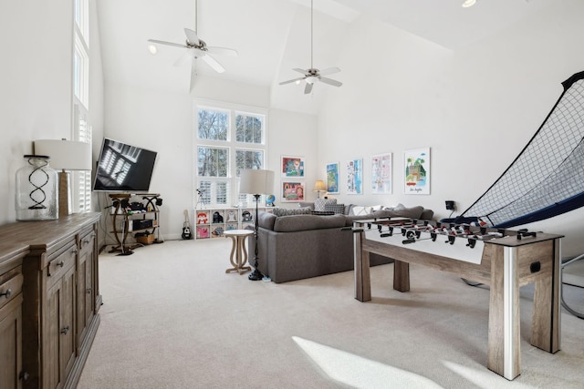 playroom featuring light carpet, high vaulted ceiling, and a ceiling fan