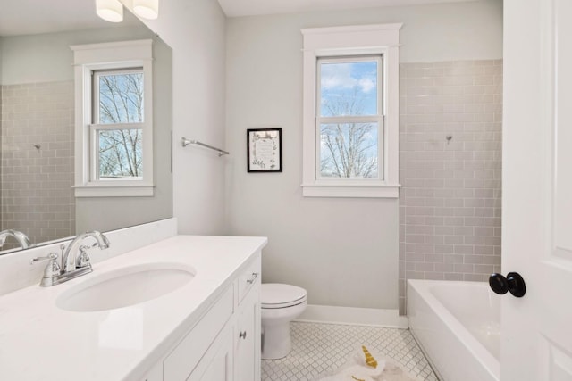 bathroom with baseboards, tile patterned flooring, toilet, and a healthy amount of sunlight