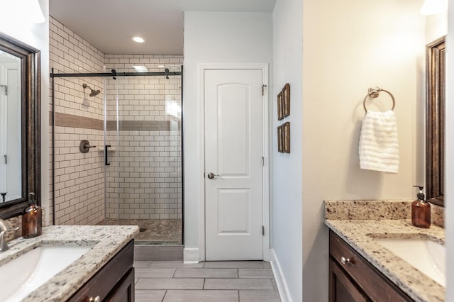 bathroom featuring a shower stall, baseboards, wood tiled floor, recessed lighting, and vanity