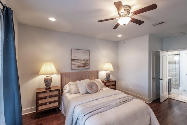 bedroom featuring wood finished floors, visible vents, and baseboards