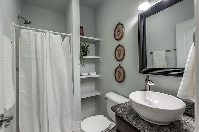 bathroom featuring curtained shower, toilet, and vanity