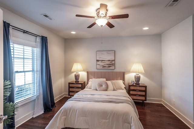 bedroom featuring visible vents, baseboards, and dark wood-style floors