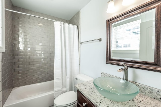 full bathroom featuring toilet, shower / bath combo, and vanity