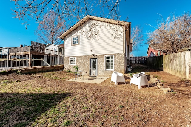 back of house featuring a patio, central AC unit, and a fenced backyard