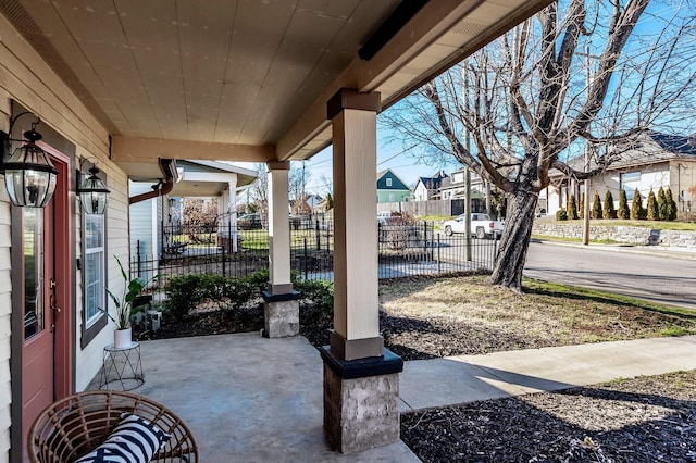 view of patio with fence and a residential view