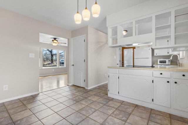 kitchen featuring open shelves, white cabinets, ceiling fan, a sink, and white appliances