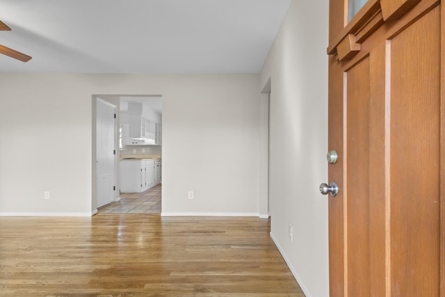 entrance foyer featuring ceiling fan, light wood-style flooring, and baseboards