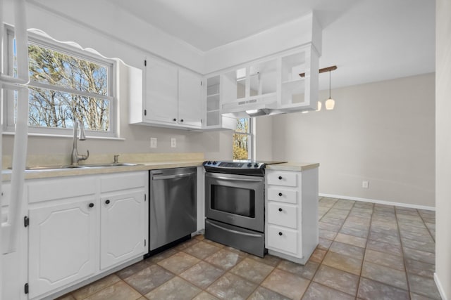 kitchen with stainless steel appliances, a sink, light countertops, and white cabinets